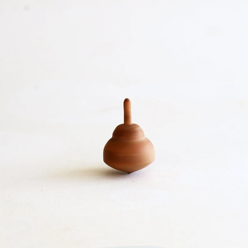 Tiny olive wood spinning tops