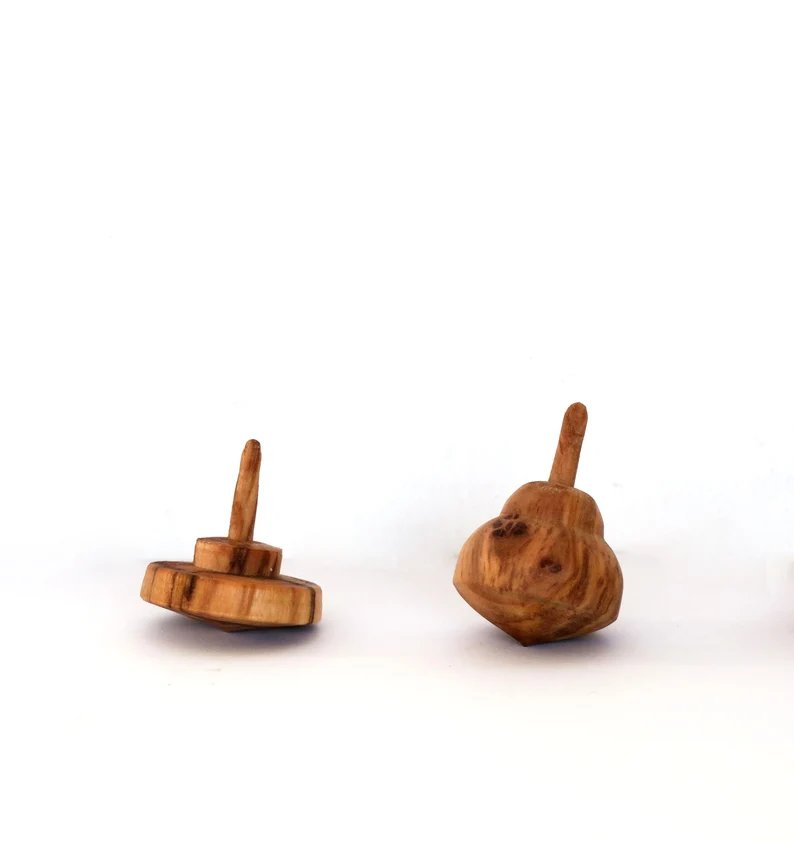 Tiny olive wood spinning tops