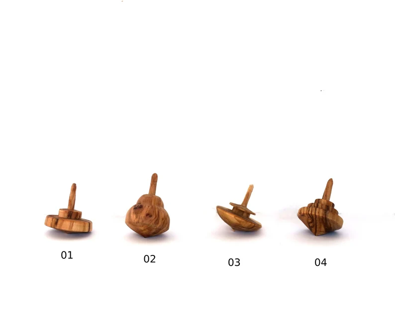 Tiny olive wood spinning tops