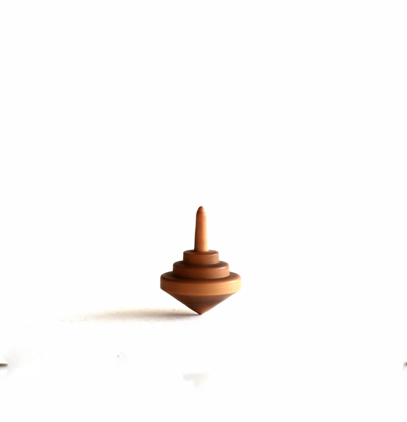 Tiny olive wood spinning tops