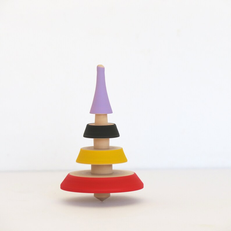 Uniquely shaped wooden spin top