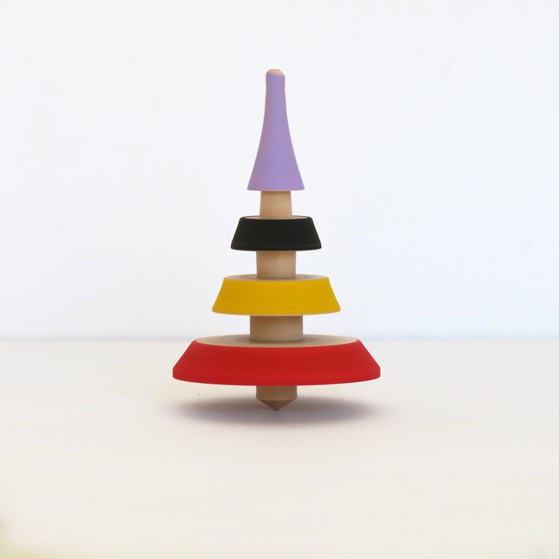 Uniquely shaped wooden spin top